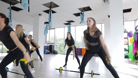 group fitness class doing exercises in a gym