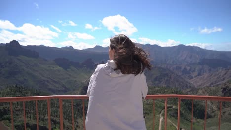 Woman-looking-at-mountains-landscape-at-viewpoint-in-Artenara,-Gran-Canaria,-Spain