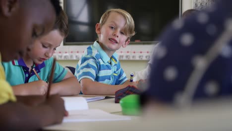 boy smiling while studying in the class