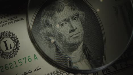 two-dollar us banknote. 2 cash through a magnifying glass.