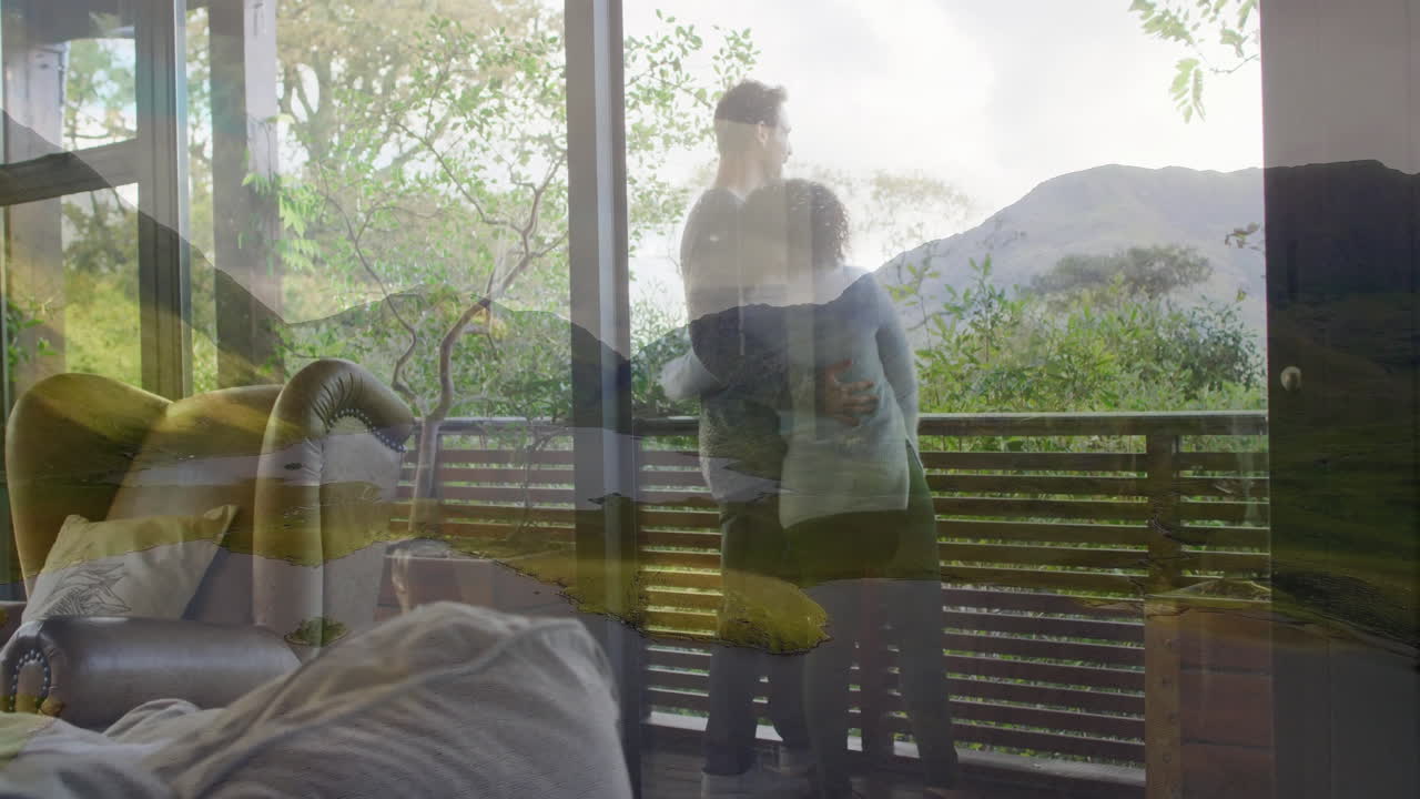 Embracing couple with nature animation overlay, enjoying mountain view from home