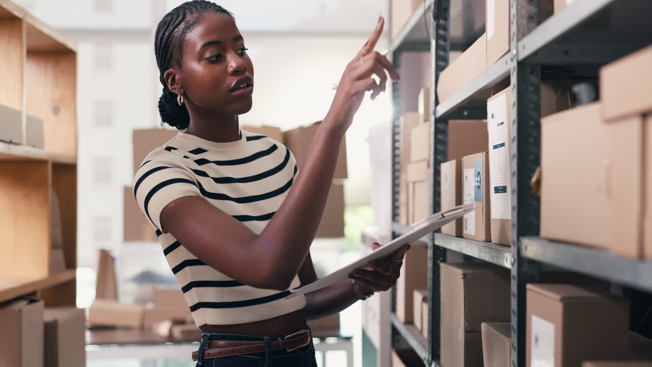 Young Woman Checking Inventory and Stock in a Warehouse