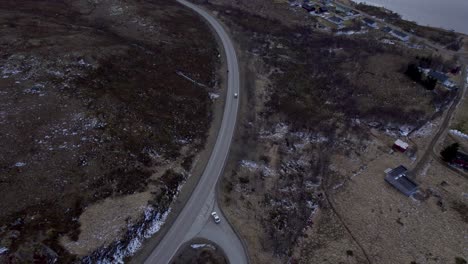 Aerial-reveal-shot-of-the-mountains-and-waterways-around-the-historic-Viking-village-of-Borg-in-Lofoten-Norway-above-the-arctic-circle-on-a-slightly-overcast-day