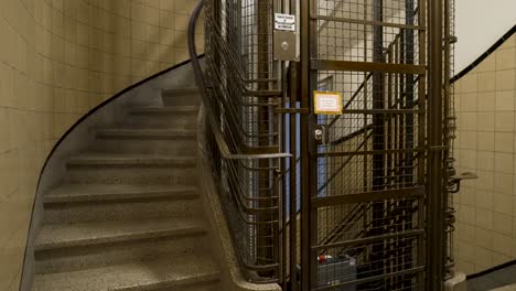 Empty-Antique-Elevator-In-An-Old-Building-Going-Down