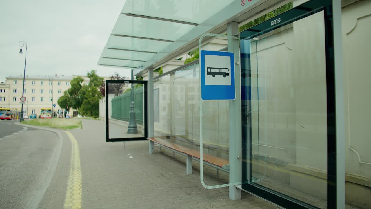 Man waiting at bus stop with backpack