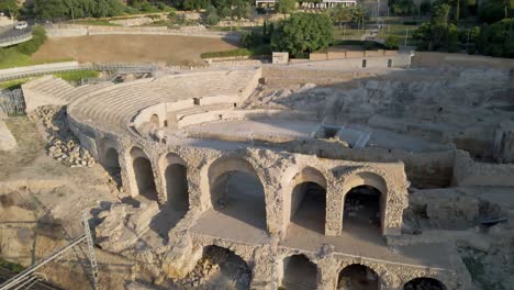 drone starts at old roman colosseum and pulls back over mediterranian to reveal the town of tarragona in spain