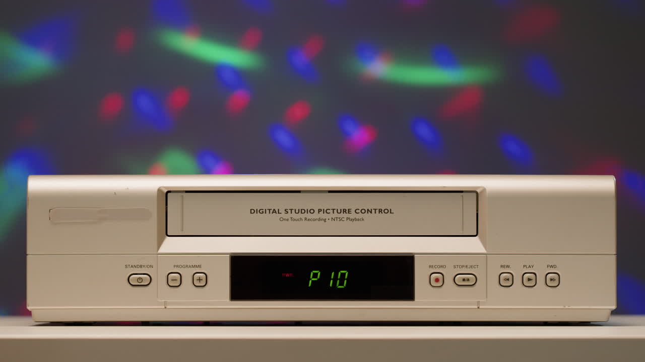 Vintage VCR against a blurred background of disco lights