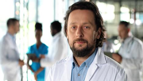 close up of handsome physician looking at camera and standing in clinic