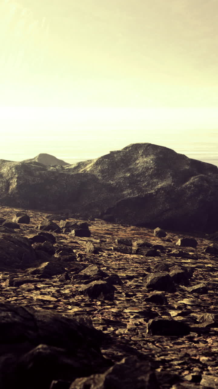 Serene landscape at dawn with misty waters and rugged stones by the shore