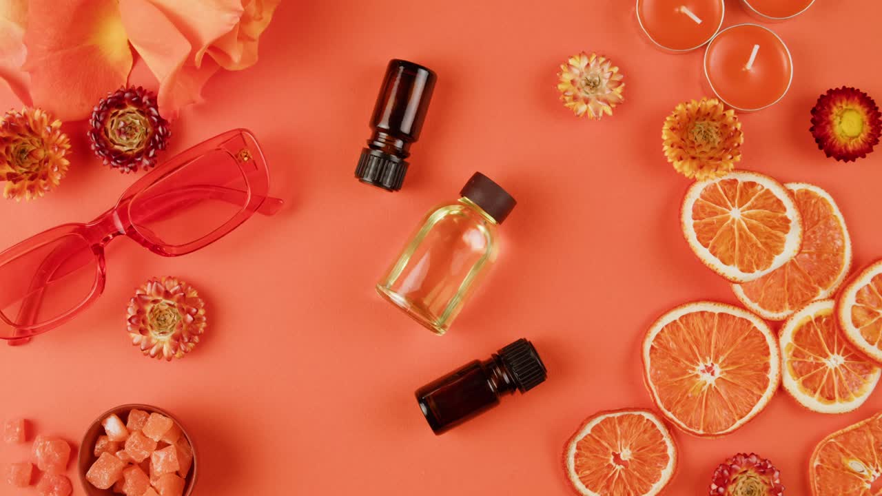 Estetica arancione corallo con oli essenziali e accessori