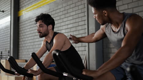 men exercising on spinning bikes in gym