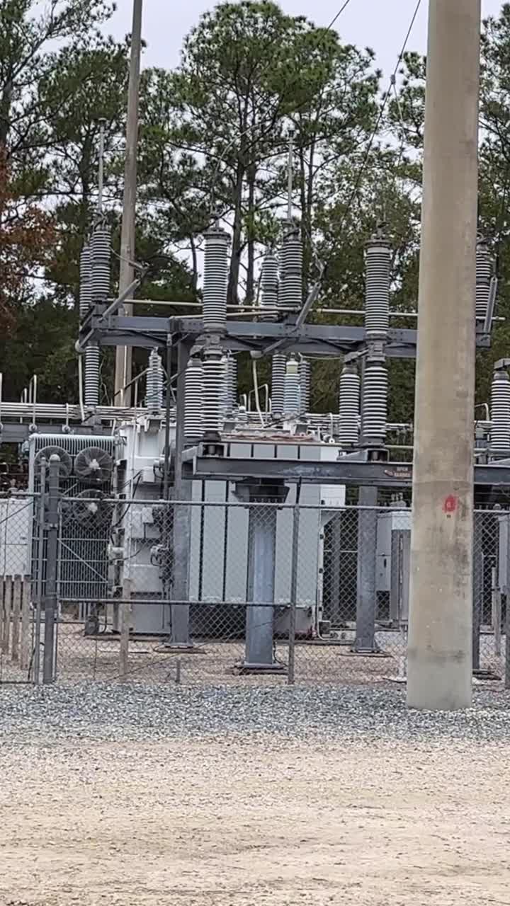 Utility station with high voltage equipment and transformer units in fenced area