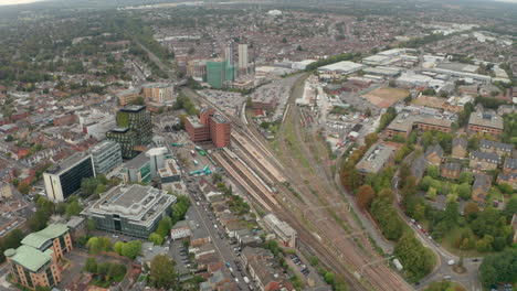 wide circling aerial shot of watford junction train station