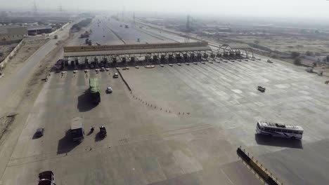 aerial view of a motorway toll plaza of the city, heavy vehicles and others entering and crossing