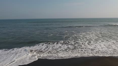 Beautiful-aerial-over-a-black-sand-beach-2