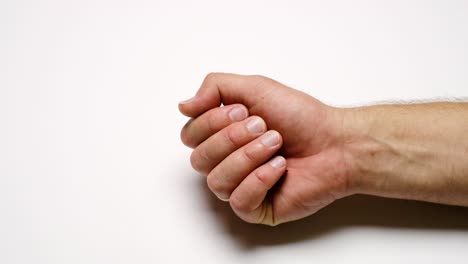 the red loop of the ribbon in the man's palm is a symbol of aids.