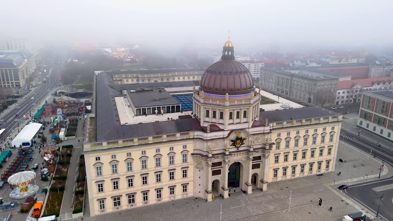 Aerial views reveal a beautiful blend of modern and historic buildings in the city. The fog adds a mysterious charm to the vibrant rooftops and iconic structures