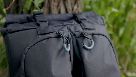 close-up-macro-shot-of-black-zipper-pull-and-fabric-of-modern-backpack-with-buckles