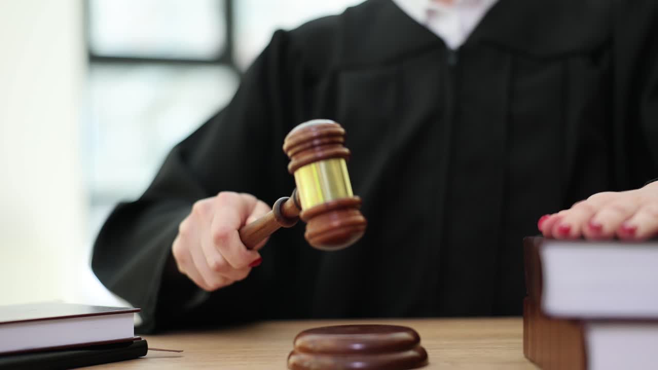 Judge holding a gavel in a courtroom