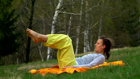 yoga and pilates exercises on the meadow in the forrest.