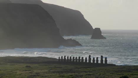 Easter-Island-statues-stand-in-the-distance-against-the-Pacific-Ocean