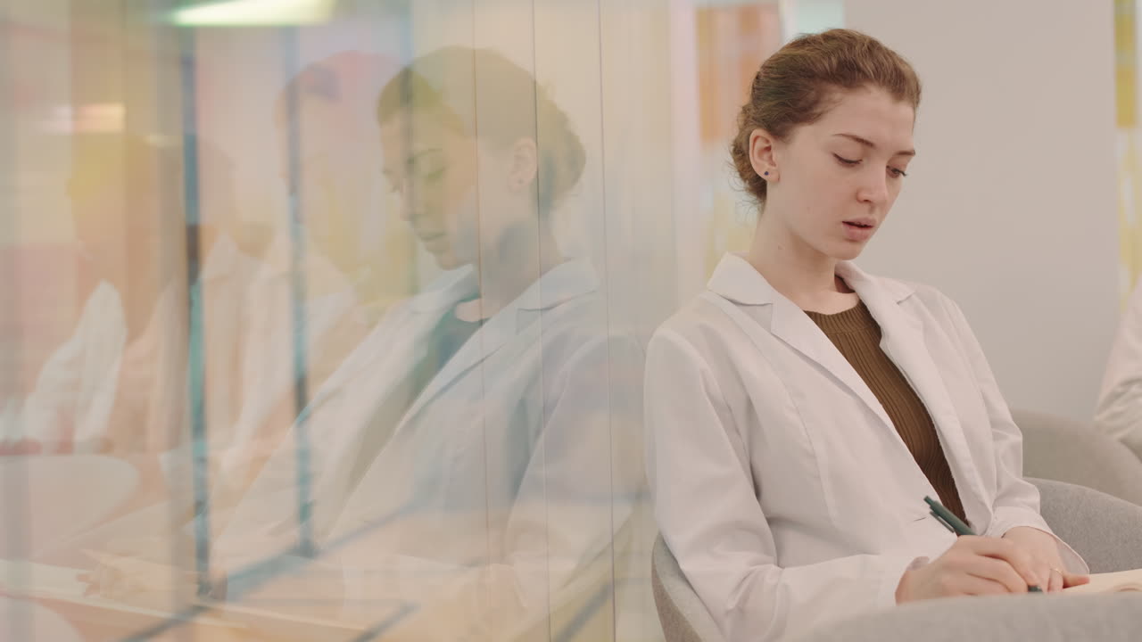 Female Medical Student Taking Notes during Lecture