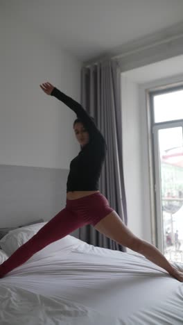 Woman practicing yoga and dance in a bedroom