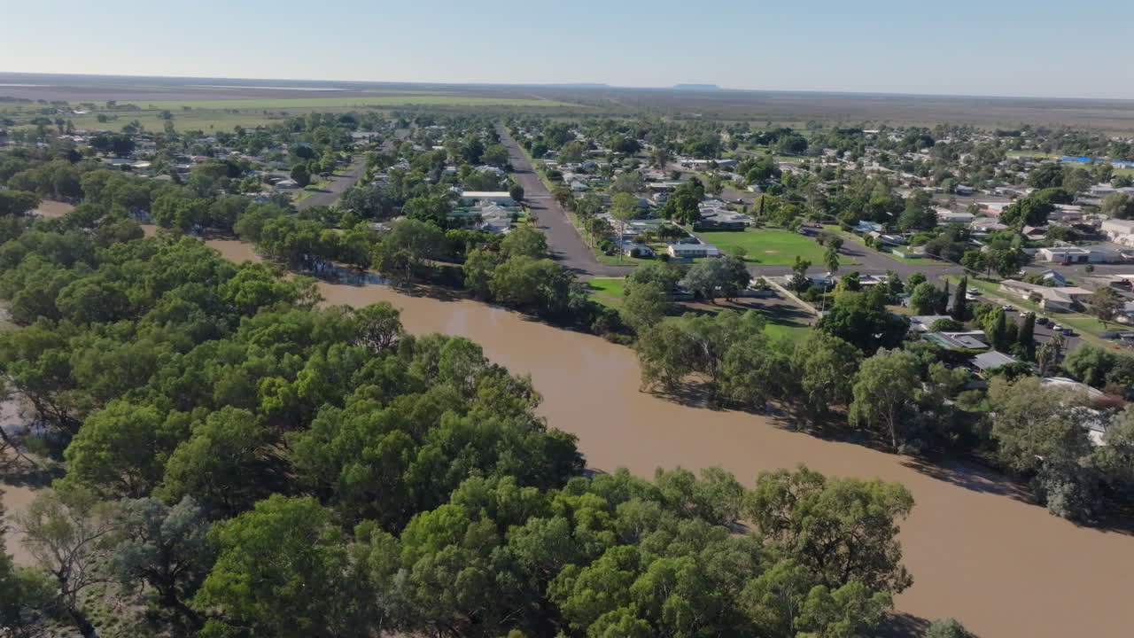 Aerial: Drone circling the overflowing Darling River running past Bourke, NSW Australia