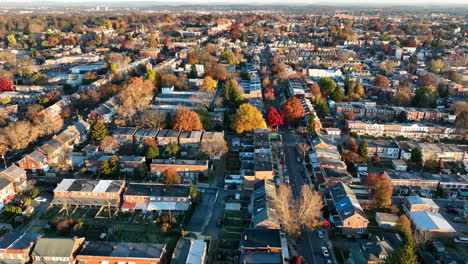 Rising-aerial-establishing-shot-of-urban-American-city-during-fall-foliage