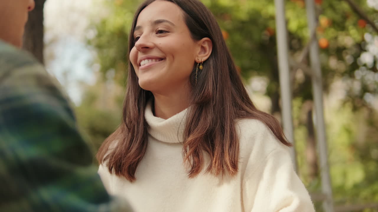 Close-up of young smiling woman looking at her boyfriend