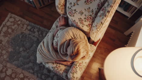 woman relaxing in a chair with a blanket