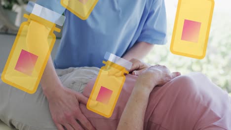 animation of box with pills icons over senior caucasian woman and nurse exercising