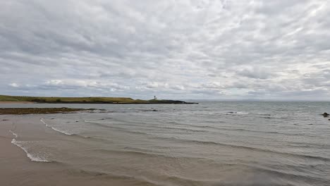 waves gently lap against the sandy shore
