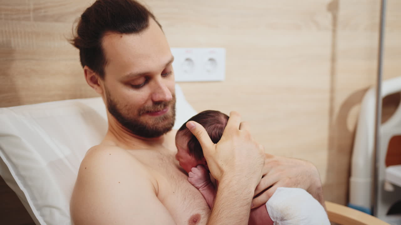 Father and Newborn Baby in Hospital