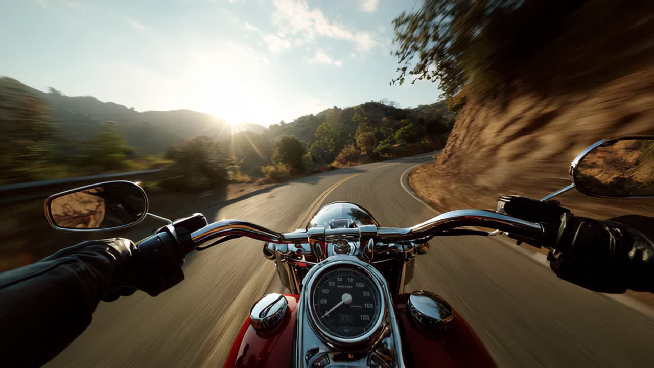 Motorcyclist navigating a scenic winding road under the sunny sky