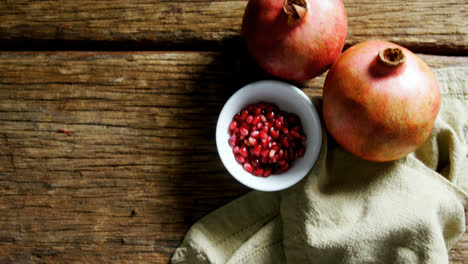 pomegranate and napkin on wooden table 4k