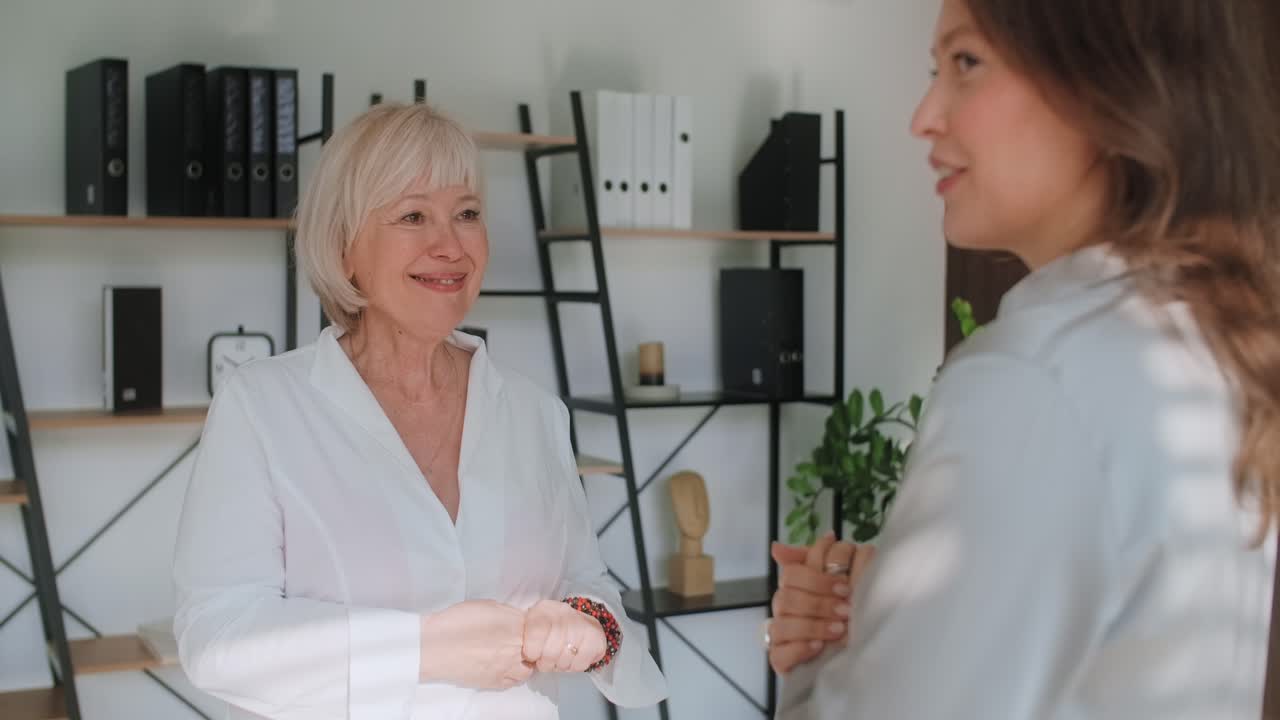Two Women Talking in an Office