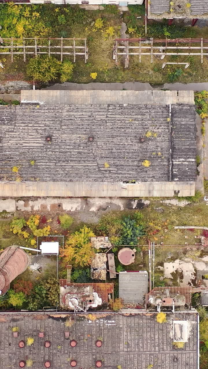 Abandoned destroyed factory territory. Old ruined empty industrial architecture. Vertical video