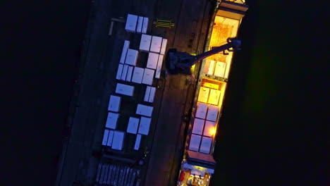 port of loading - loading shipping vessel with containers at night