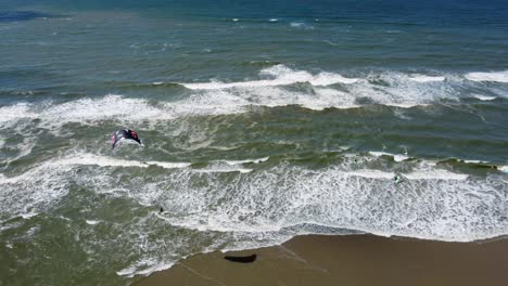 Kite-surfer-being-pulled-along-on-the-surface-of-the-sea-by-parachute