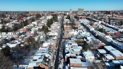 straight street in snow capped american town during winter season