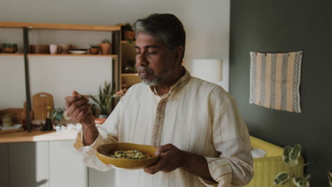 indian man enjoying a delicious and healthy meal at home