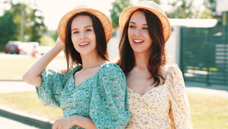 two happy women in straw hats