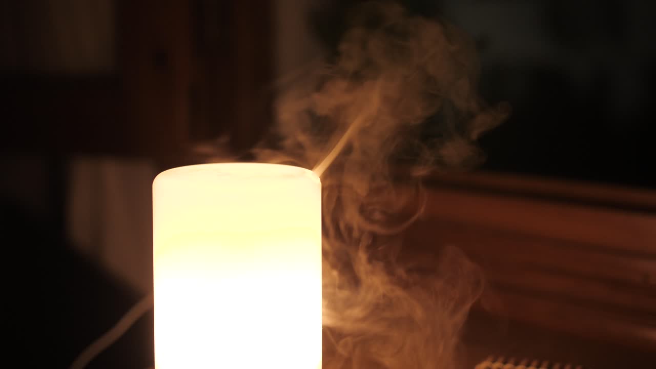 Vapor From Aroma Oil Diffuser Lamp On The Table