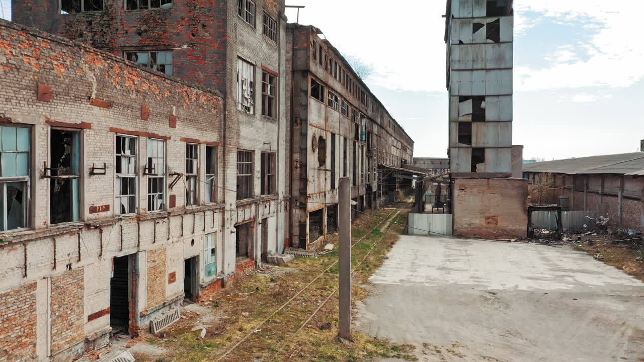 Aerial view of an old factory ruin and broken windows. Old industrial building for demolition.