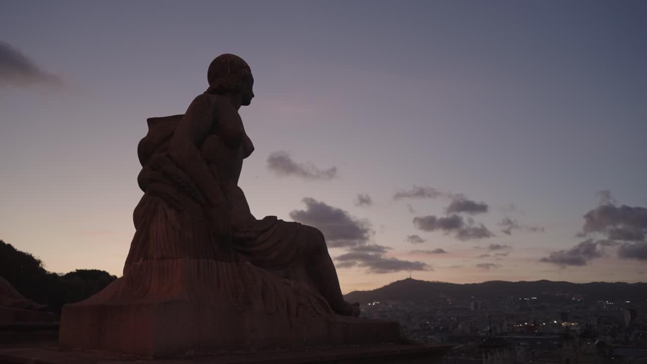 Statue overlooking Barcelona at dusk
