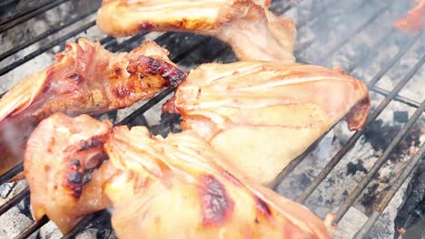 detailed view of pig ears sizzling on a smoky barbecue grill, showcasing texture and char marks.