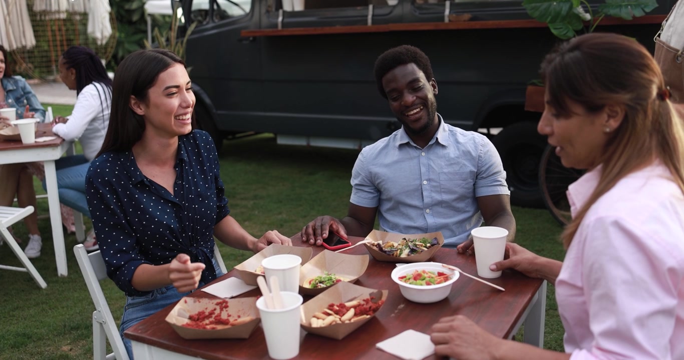 Diverse Friends Enjoying Food and Conversation at Outdoor Food Truck Event