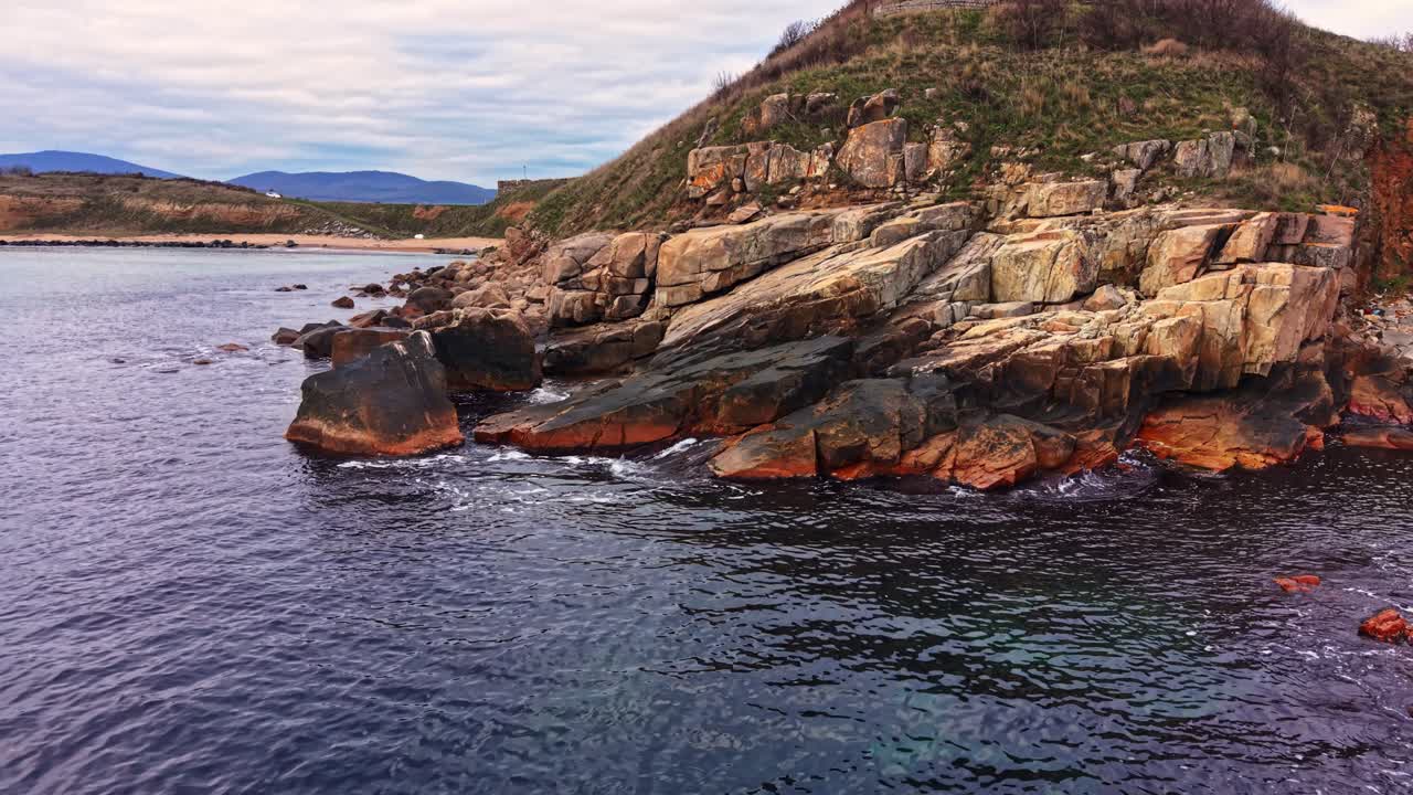 Aerial view of rocky coastline with calm waters
