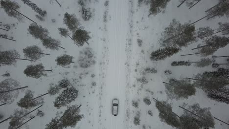 cars driving through a snow covered landscape near kuusamo, finland